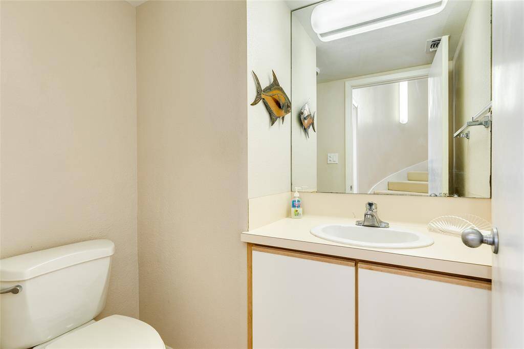 A half bath for guests on the main level, tucked away beside the utility room.