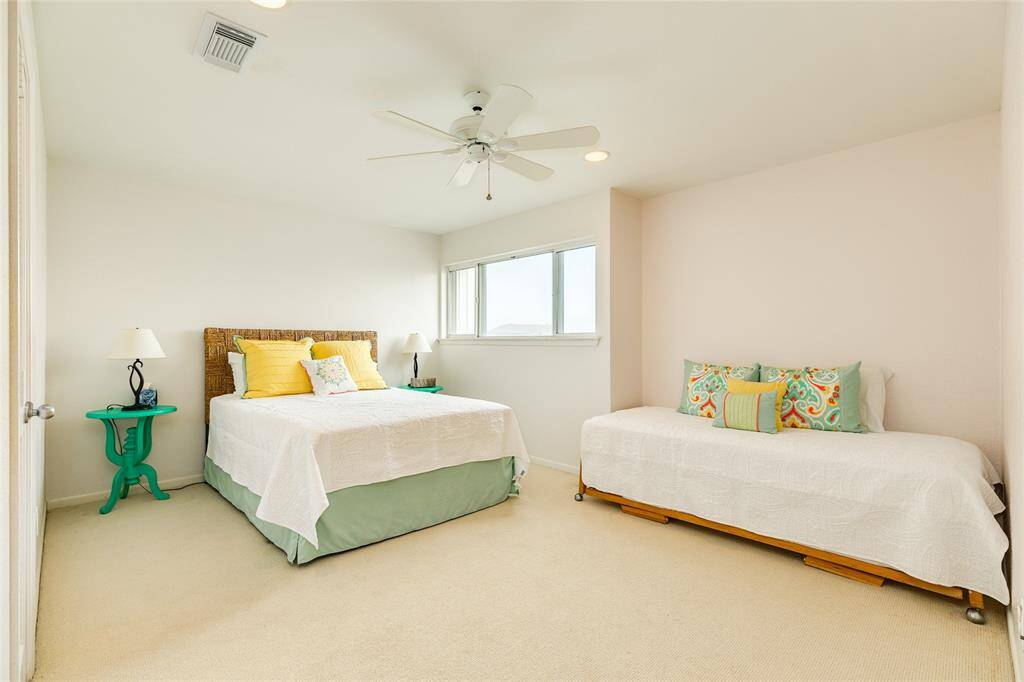 The second-level Primary is quite large. It's currently holding a queen bed and a twin bed. This room features a Gulf view, a walk-in closet and an en-suite bath.