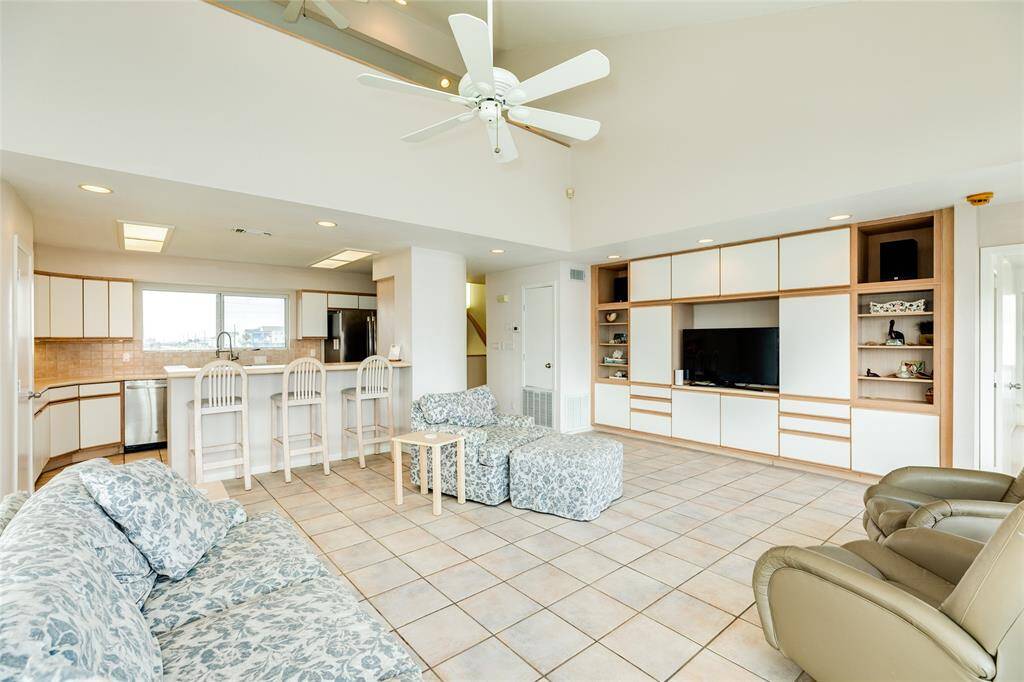 This angle shows the open flow to the kitchen with breakfast bar.