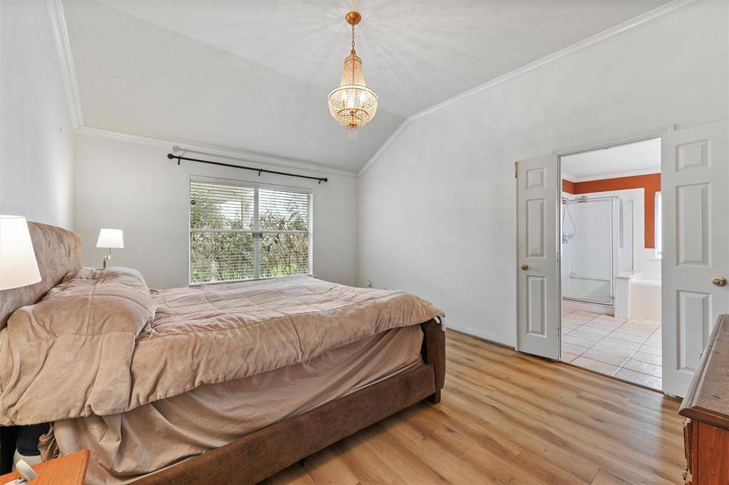 Master bedroom overlooks backyard.
