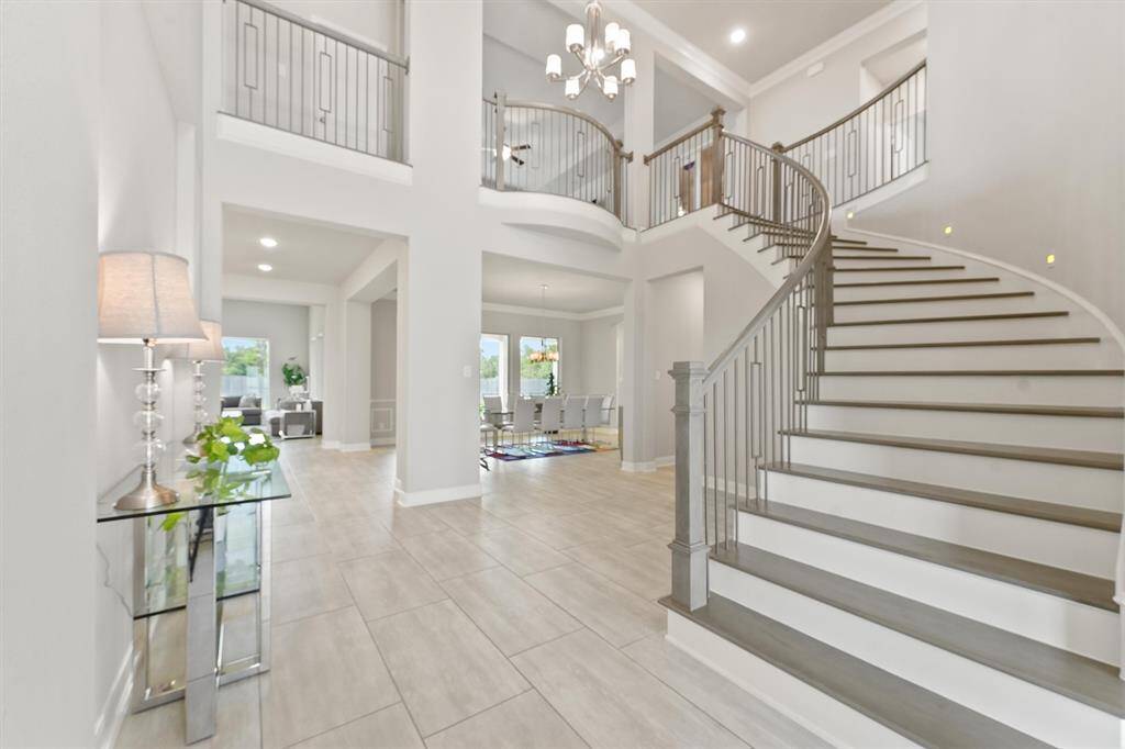 Step into elegance with a bright, airy winding staircase that welcomes you home.