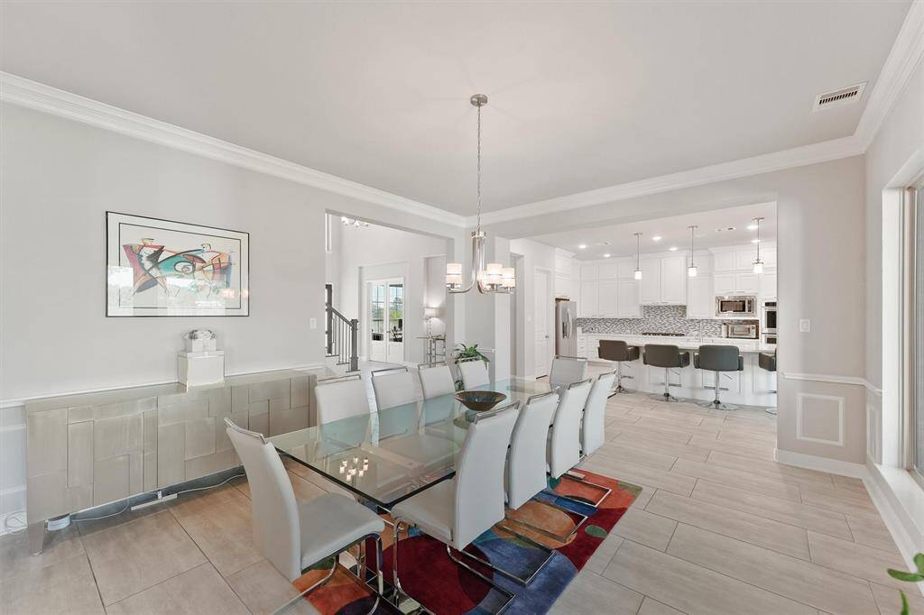 Ample lighting and a large window enhance the airy feel, while the bar seating in the kitchen adds functionality.