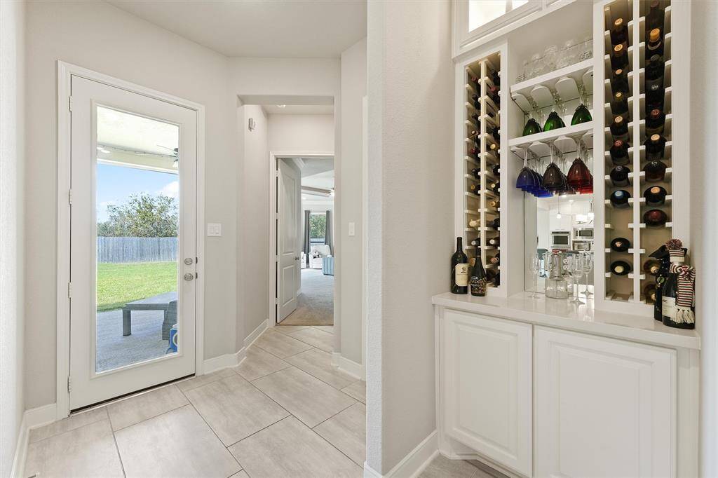 Built-in wine rack and bar area with storage, adding elegance and functionality.
