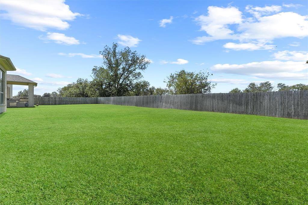 Expansive backyard ready for your personal touch—ideal for entertaining and play.