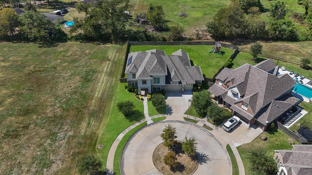 Spacious two-story home located at the end of a cul-de-sac, featuring a large, well-maintained lawn and backyard. The property is adjacent to open green space, providing a sense of privacy.