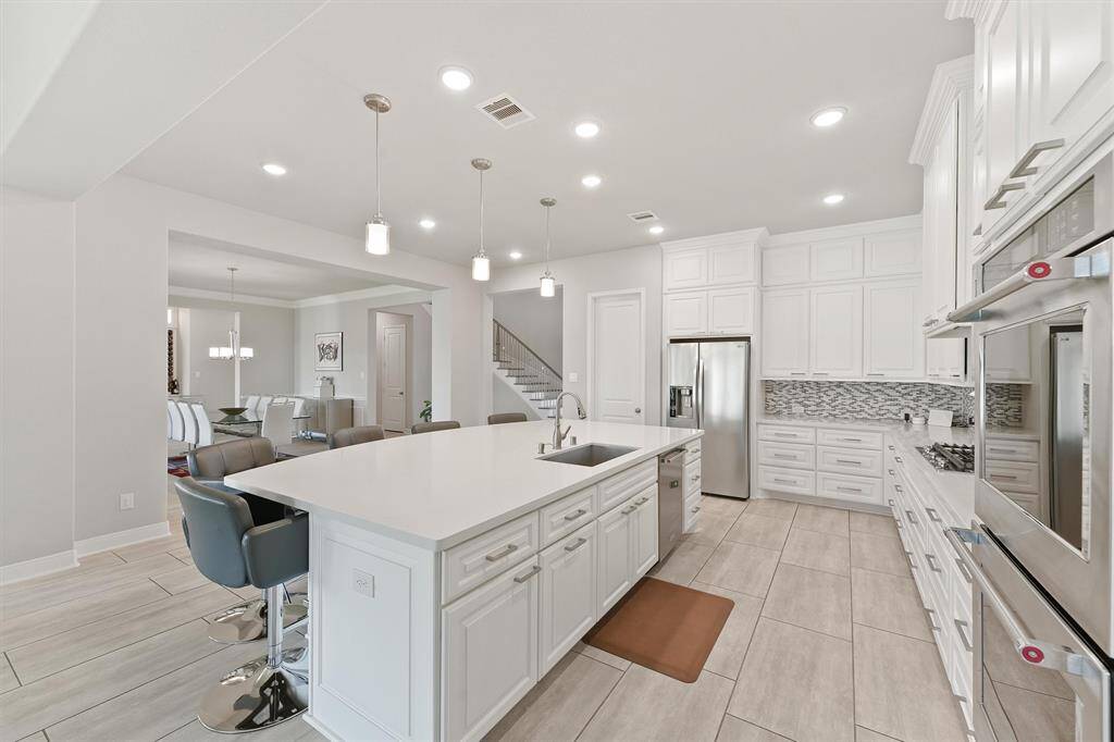 The kitchen flows seamlessly into a dining area, creating a spacious and inviting atmosphere.