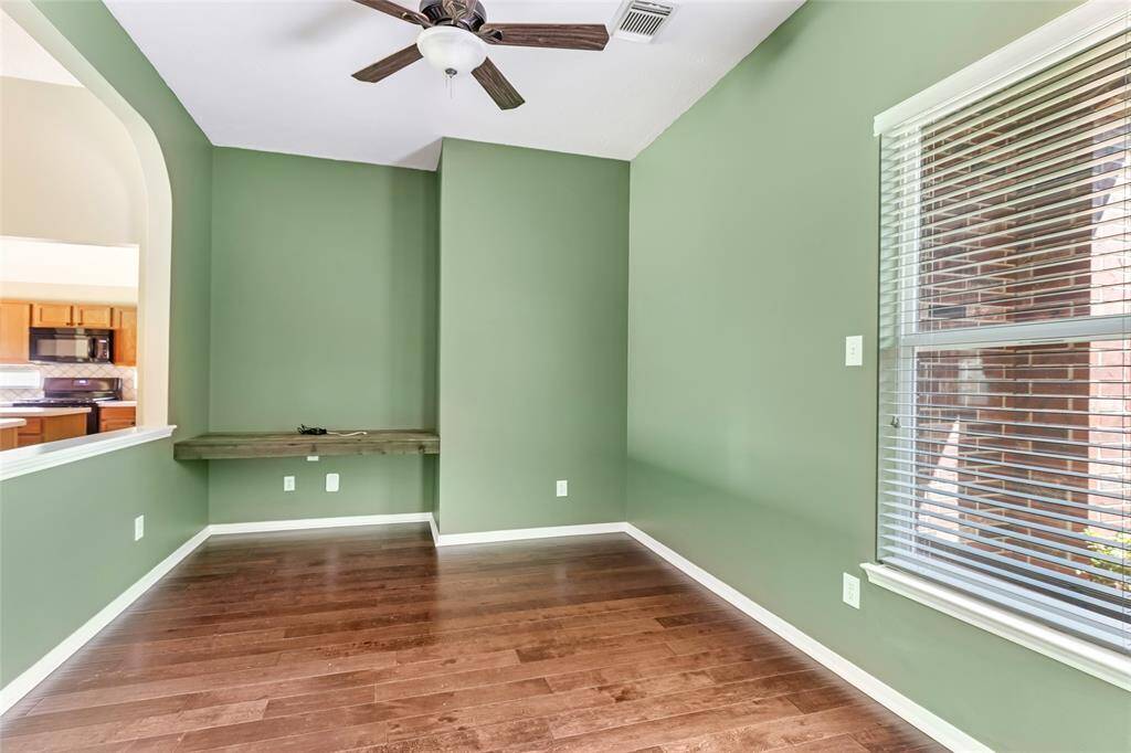 Office/study space with ample natural light and functional layout. Including a custom built-in desk
