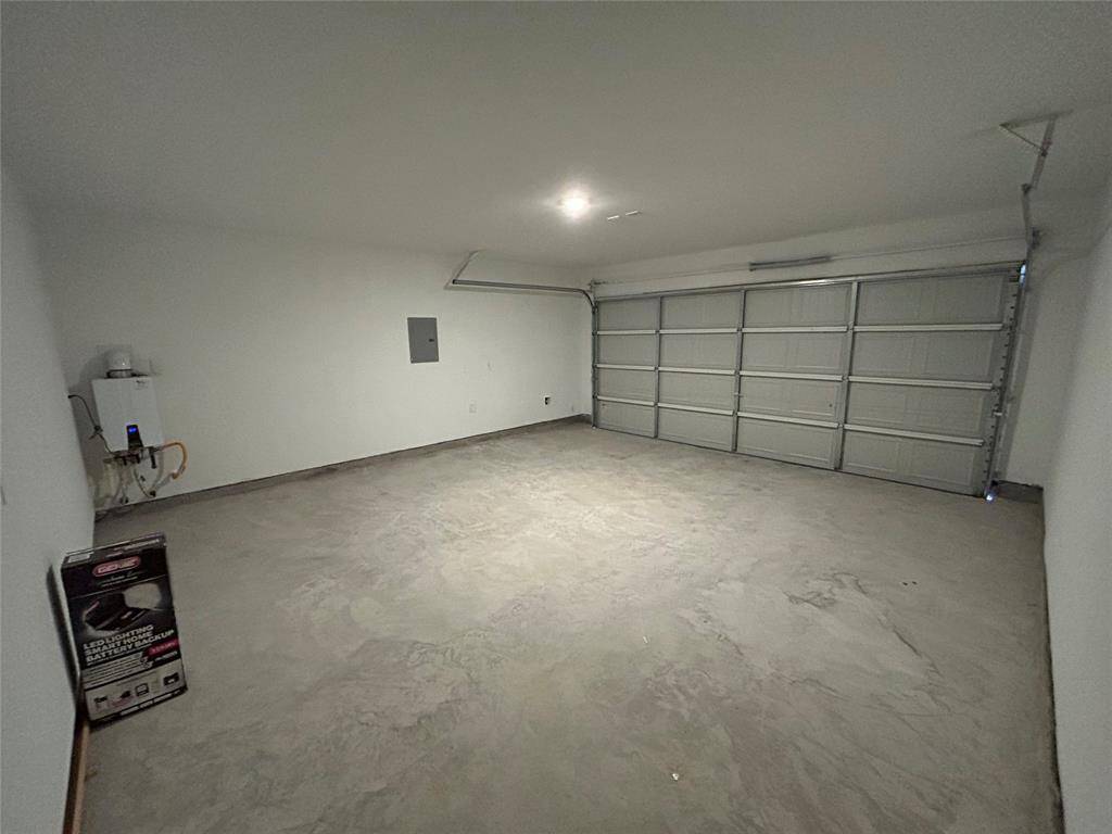 See Garage Door Opener Box on the Floor scheduled to be installed in a couple of days. Also note Tankless Water Heater on extreme end which allows for instant Hot Water Supply.