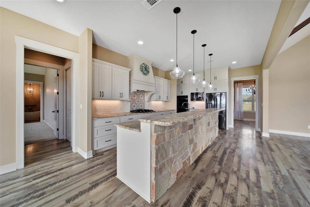 View from the kitchen nook to the primary suite, butlers pantry, and bathroom.