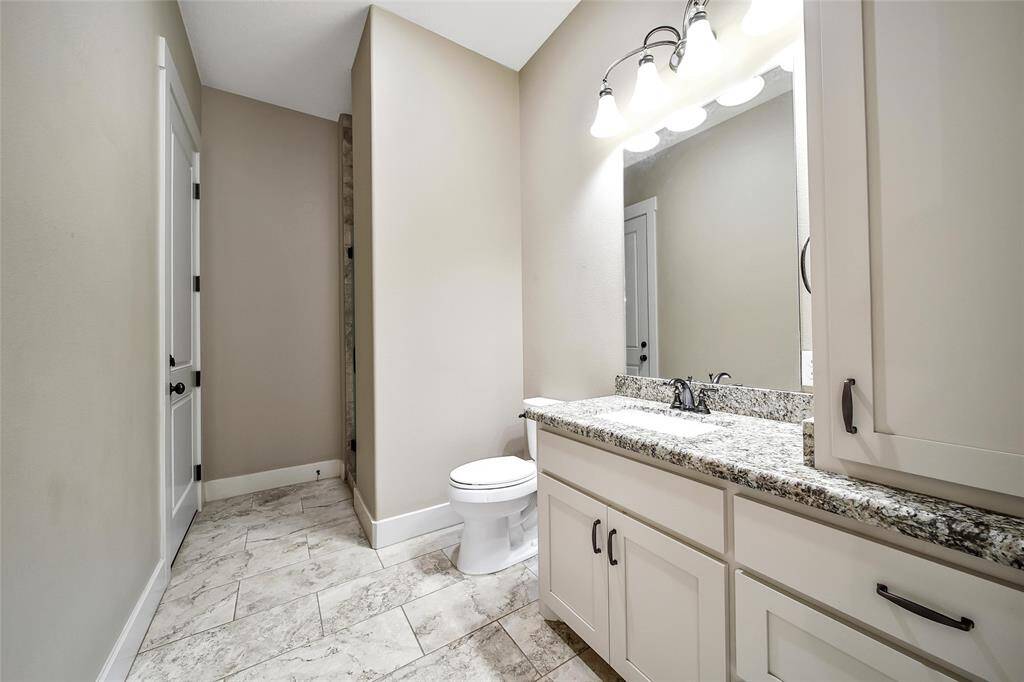 As we leave the primary suite, you'll find a full bath with a shower and access outside. Perfect for washing up after a long day of working livestock.