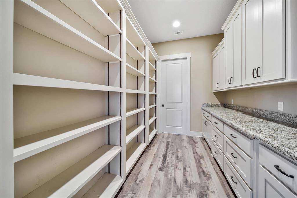 Across from the bathroom is the butler pantry. Two pocket doors will allow the space to be shut off. Look at the storage!!!