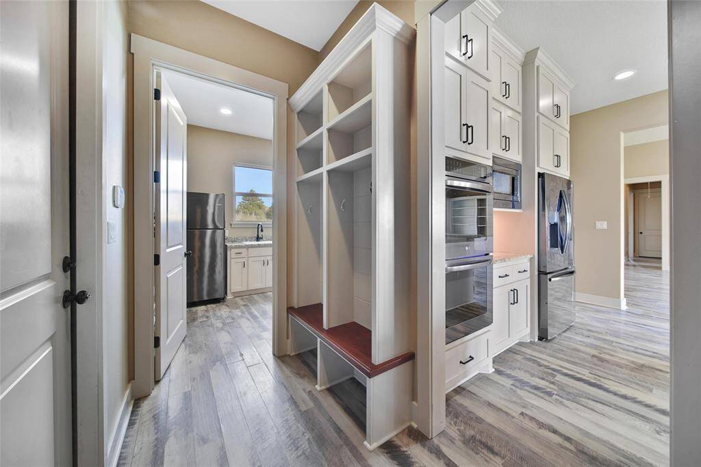 From the garage entry, there is a mud room set up. Hang up your backpaks here, put the boots under the bench and drop your clothes in the laundry room please.