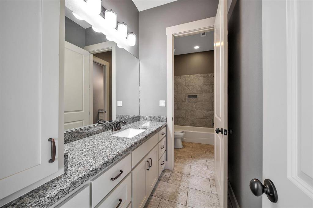 Private vanity and dressing room located off bedroom number one.