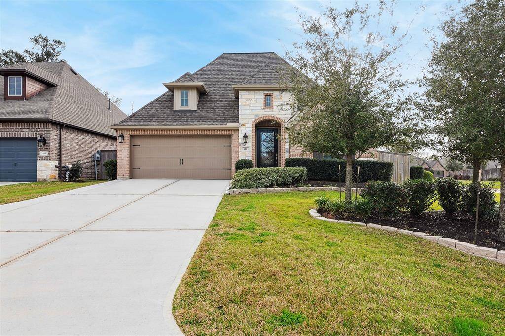 Brick and Stone front elevation and lush landscaping really makes this home a standout!