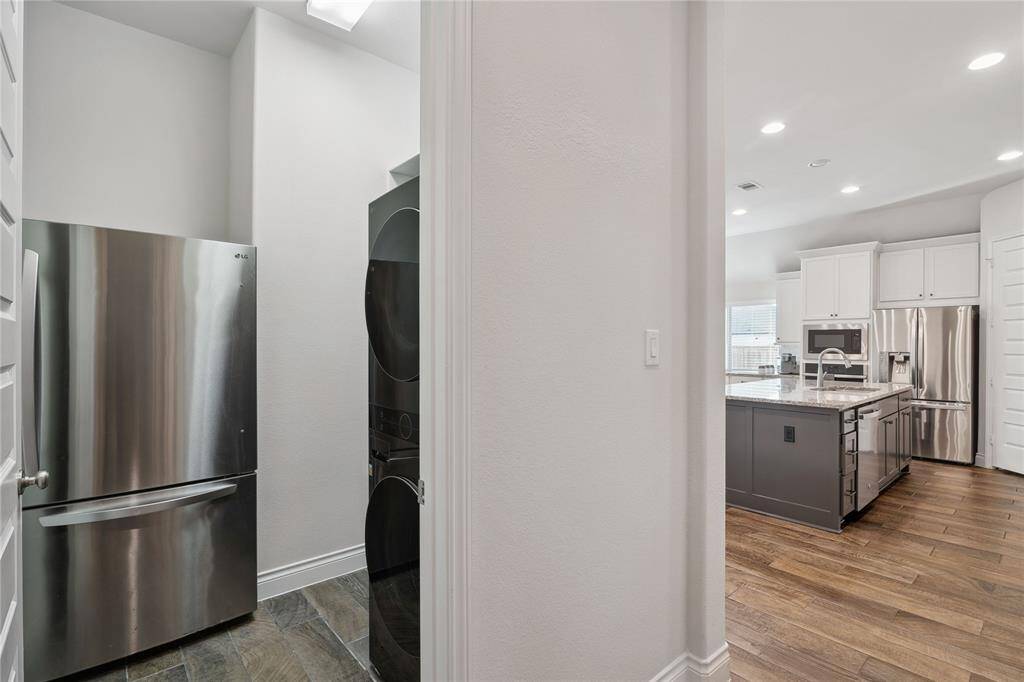 To the left of the kitchen and past the mud room, you enter the utility room with enough room for your washer, electric or gas dryer and refrigerator!