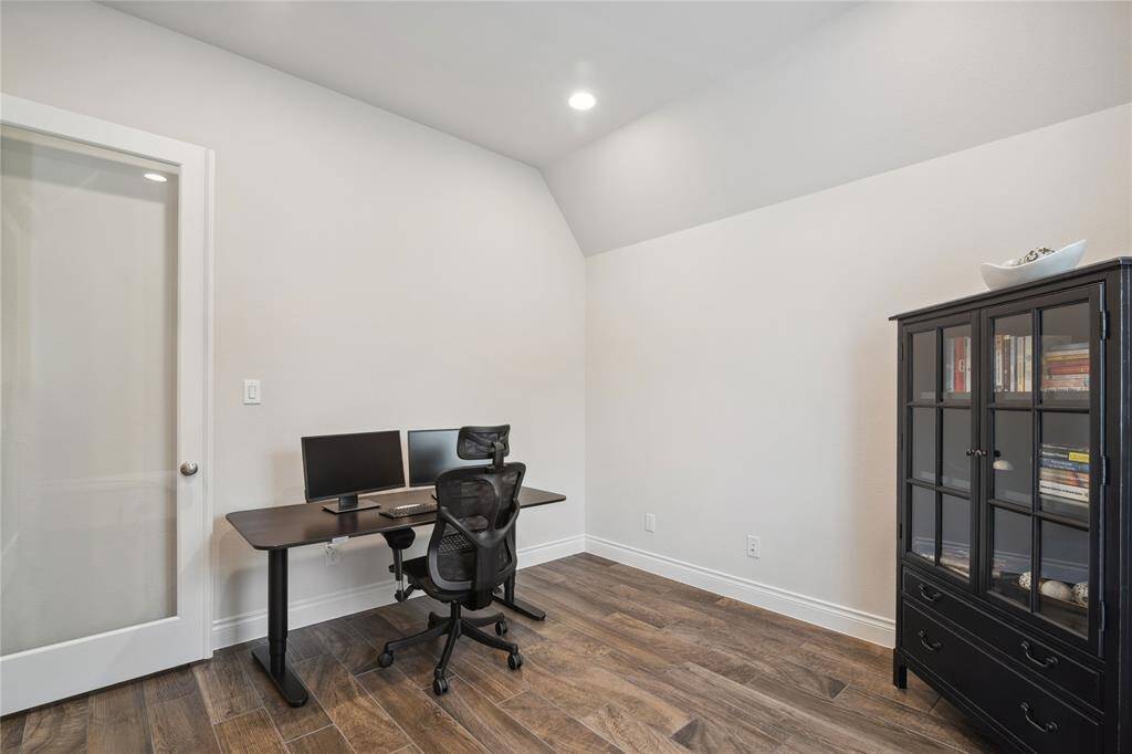 Full Glass French Doors and 12'ft ceilings add to this very spacious home office!