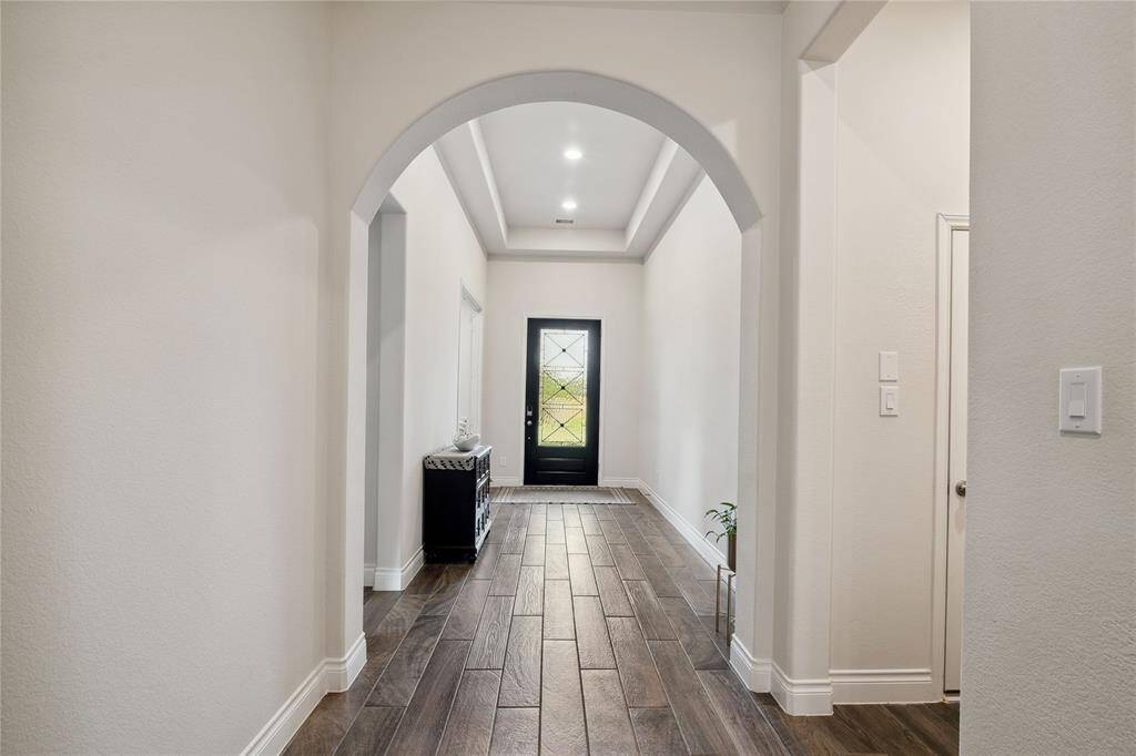 Dramatic 12' entry with coffered ceiling with arch entry into the open floor plan, is a showstopper view when hosting guests!