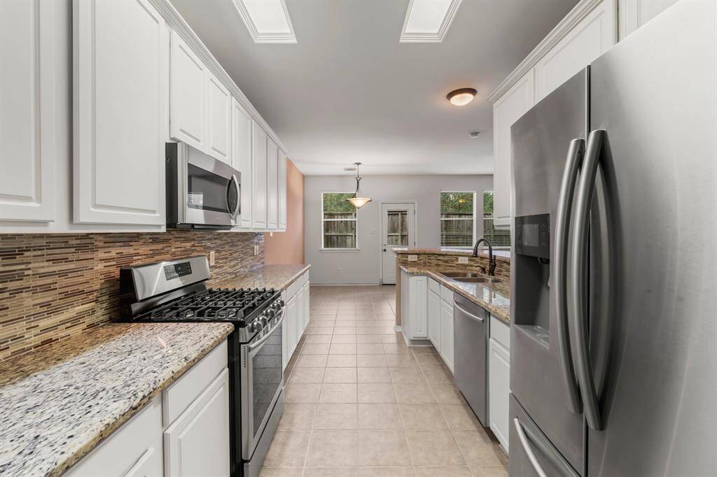 A pristine view of what this extraordinary kitchen has to offer.  Samsung stainless steel appliances include 5 burner gas range and oven, dishwasher, microwave, and refrigerator. This elegant kitchen boasts plenty of rich wood cabinets and sleek granite counter top workspace. Click on the movie reel icon, or visit our on-line documents for a QR code to view our walk-through video.