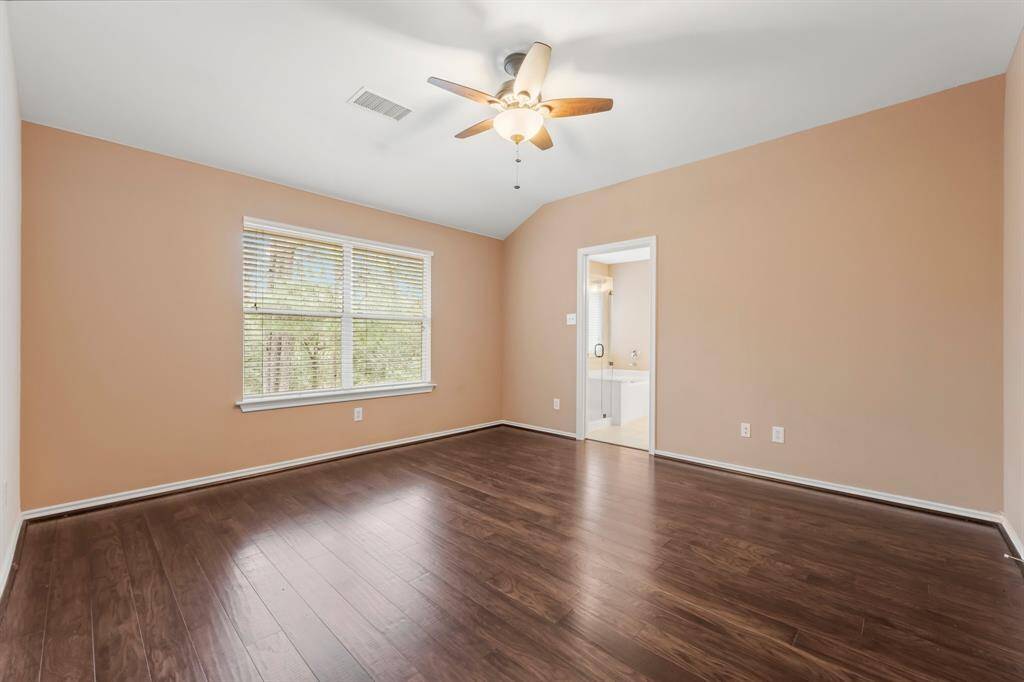 This sophisticated Owners’ Suite is highlighted by wood flooring, high ceilings, lighted ceiling fan, and an en-suite bath with large walk-in closet with built-in shelving. Everything you need to escape from a hectic day and relax.