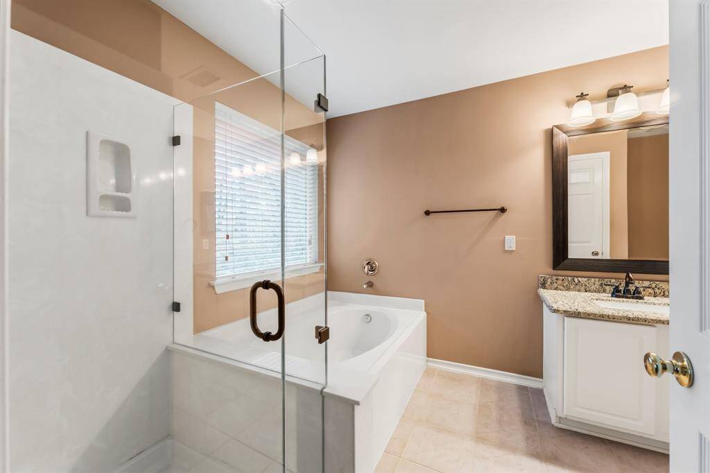 Your Owners’ en-suite bath features tile flooring, dual rectangular undermount sinks, granite counter top, medicine cabinet, linen closet, framed mirror, toilet, relaxing soaking tub, and a large shower with built-in toiletry niche.