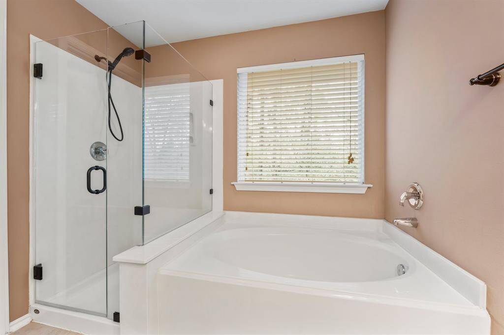 The large soaking tub is perfect for relaxing, and the shower provides an invigorating wake-up in the morning. The large walk-in closet has built-in shelving and plenty of hanging space.