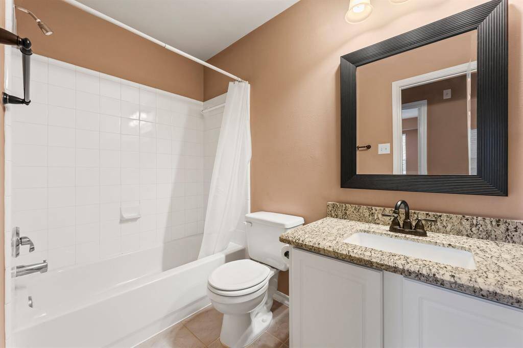 2nd full bathroom for Bedrooms 2 and 3 includes single rectangular undermount sink, granite countertop, hallway linen closet, medicine cabinet, toilet, framed mirror, and tiled shower/tub combo.
