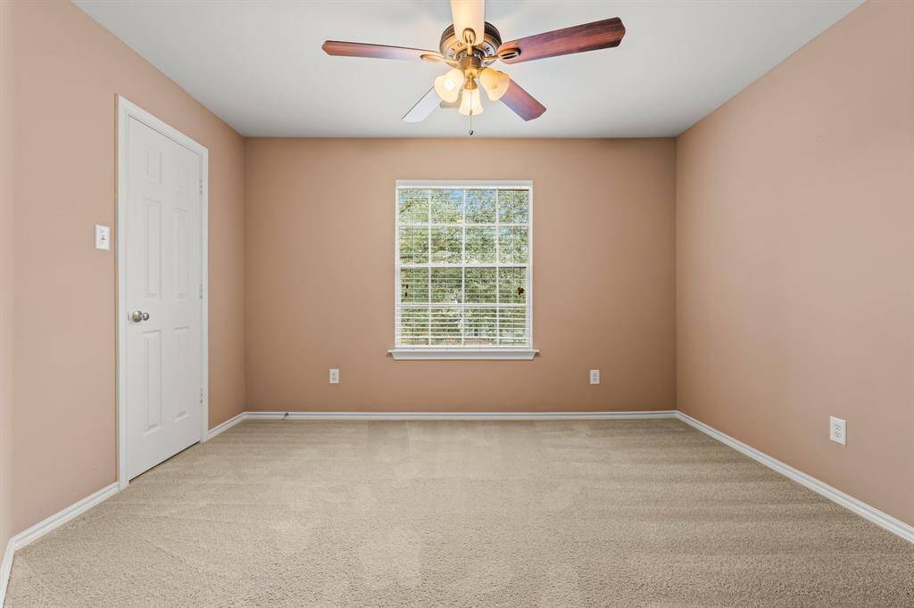 A secondary bedroom offers a sunny window with privacy blinds,  lush carpeting, large walk-in closet with window, and a lighted ceiling fan. It has hallway access to a full bath shared with Bedroom 2.