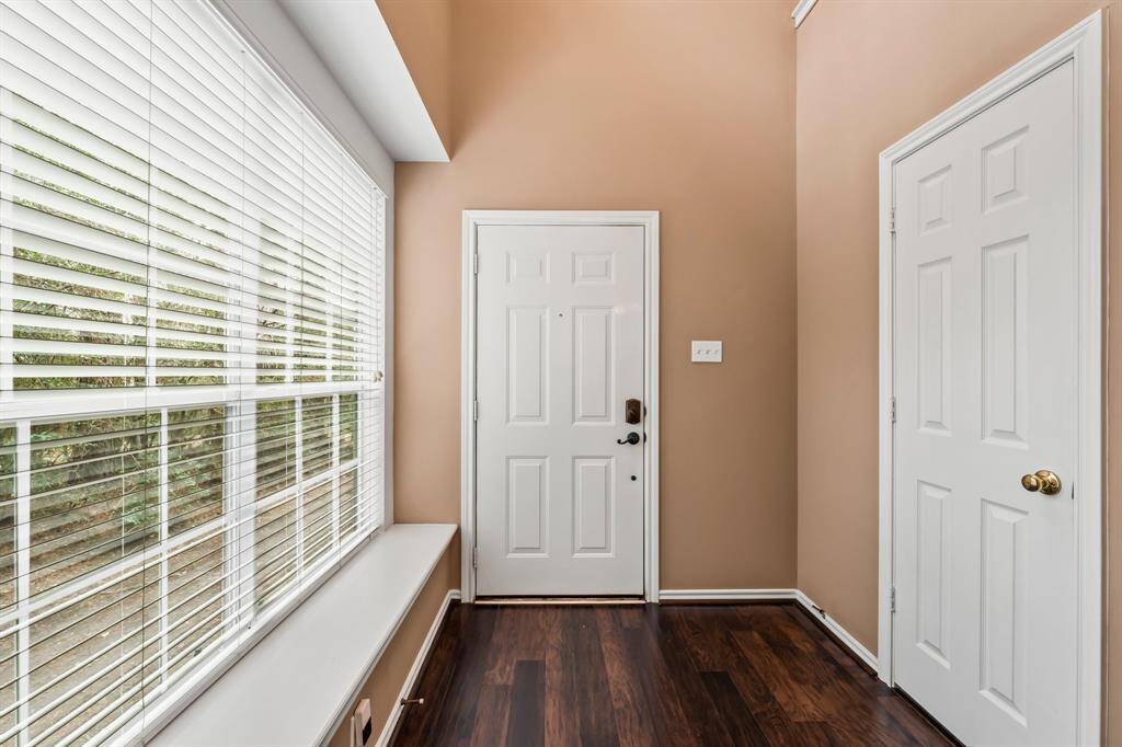 Another view of the Foyer, with the large window and window seat on the left, and the guest half bathroom on the right.
