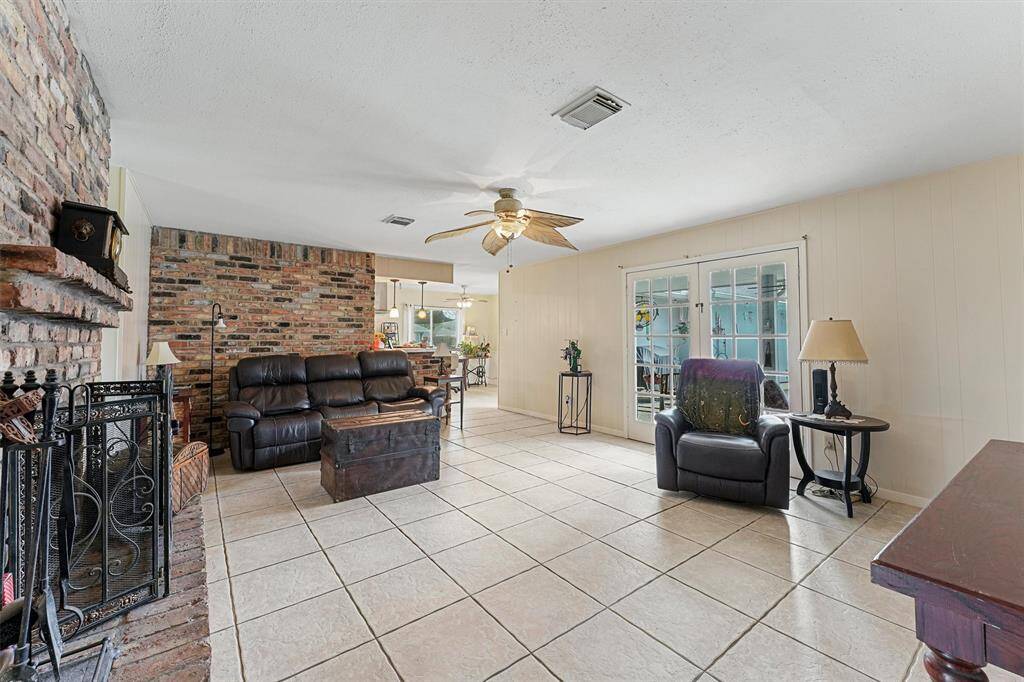 Living room with french doors leading out to the backyard oasis.