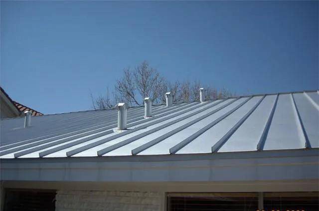 This photo shows a modern metal roof with multiple vent pipes, offering durability and a sleek appearance. Ideal for low-maintenance and energy-efficient homes.