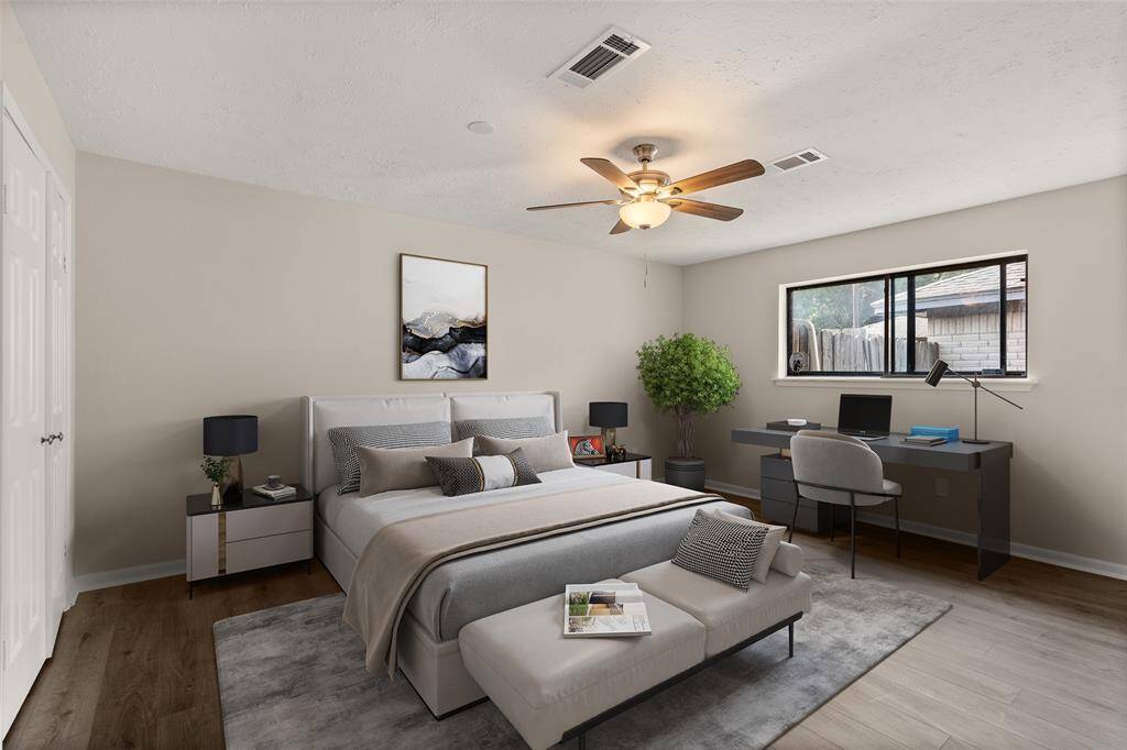 What a wonderful place to come home to, this stunning primary suite greets you with gorgeous flooring, warm custom paint, high ceiling, ceiling fan with lighting, and a large window allowing in natural light brightening up this spacious primary bedroom.