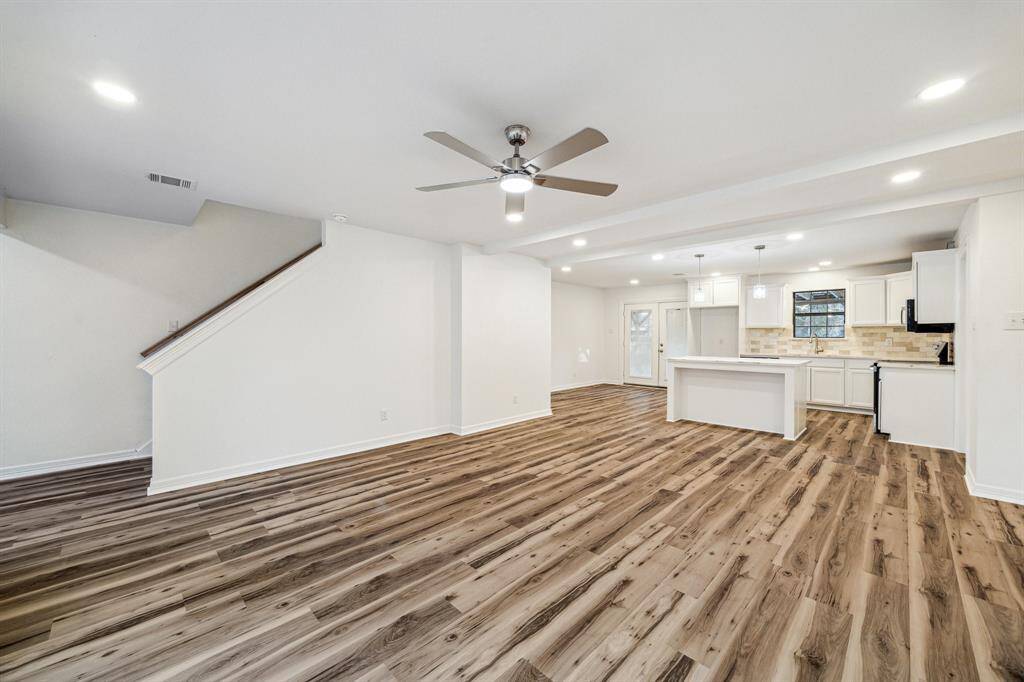 Spacious living room with view of the kitchen