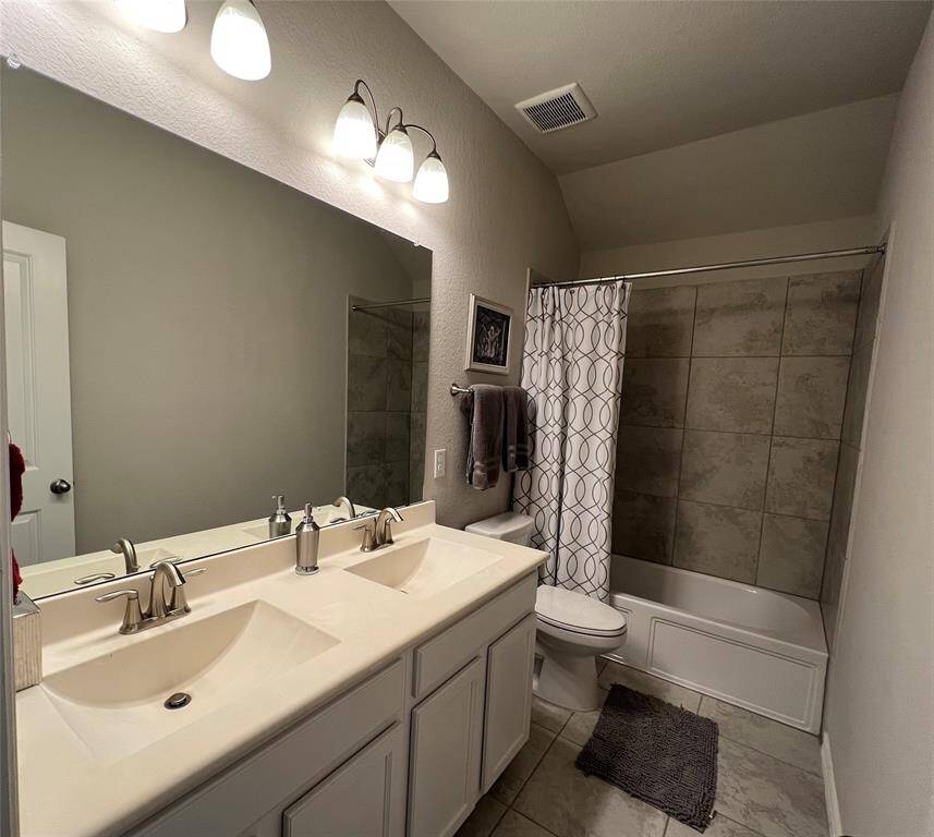 Guest second level bath features dual sinks.