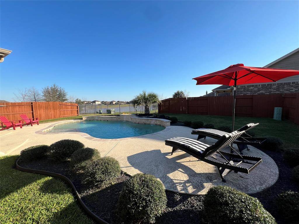 Resort style backyard features pool and inviting waterfront living.