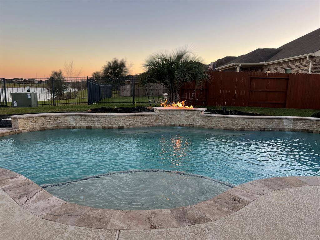 Custom firewall add additional luxury to well maintained backyard.