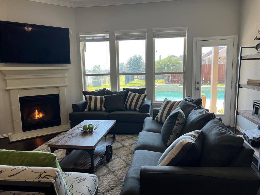 Family room features high-end handscraped wood flooring and inviting views of extensive backyard and covered patio. Excellent space for entertaining!
