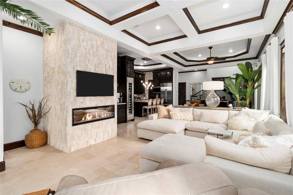 Gorgeous stone wall with a modern fireplace.
