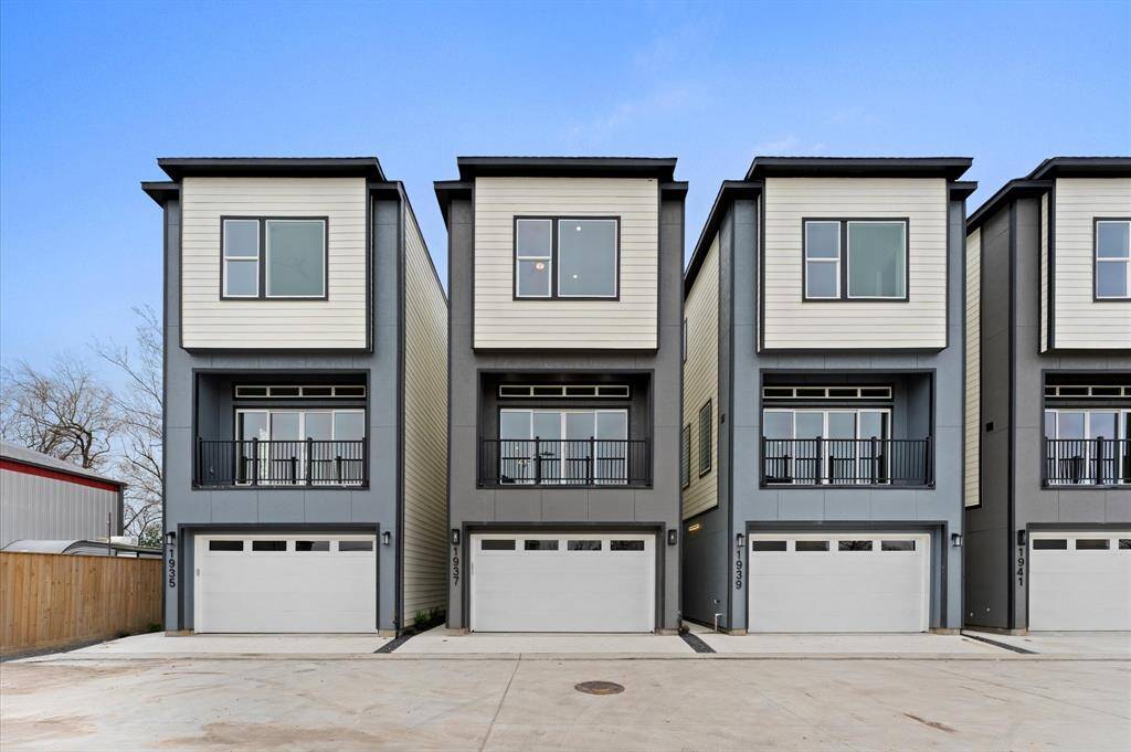 This home features an open-concept virtually staged living area with sleek LVP floors, a modern kitchen with a central island and stylish lighting, and a contemporary staircase leading to the upper floor. The space is bright and inviting, ideal for entertaining and family living.