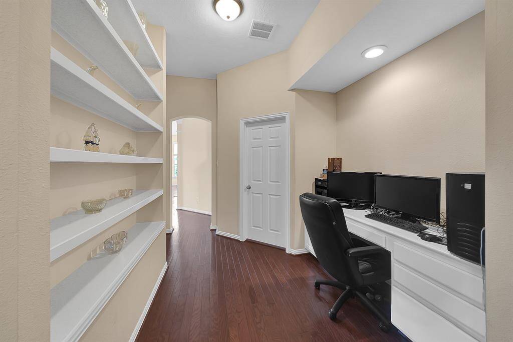 Computer nook conveniently located off the living room and kitchen with built-in shelving.