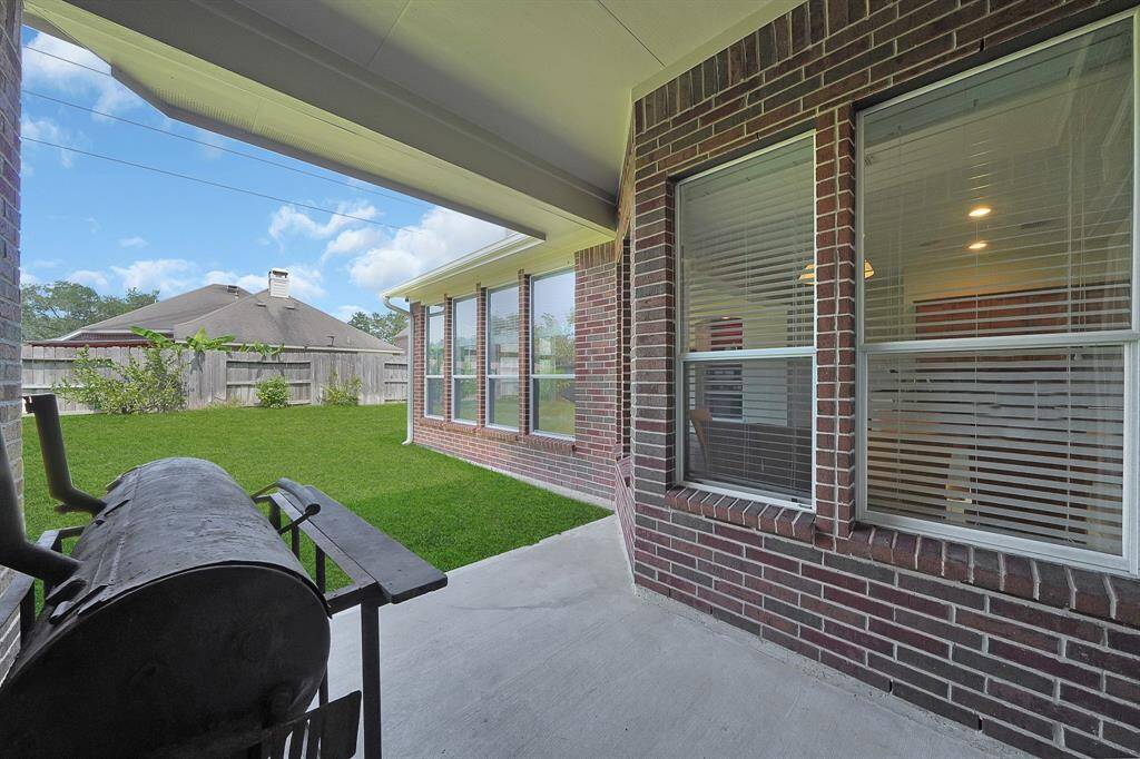Covered back patio is perfect for outdoor dining or grilling your favorite meals.