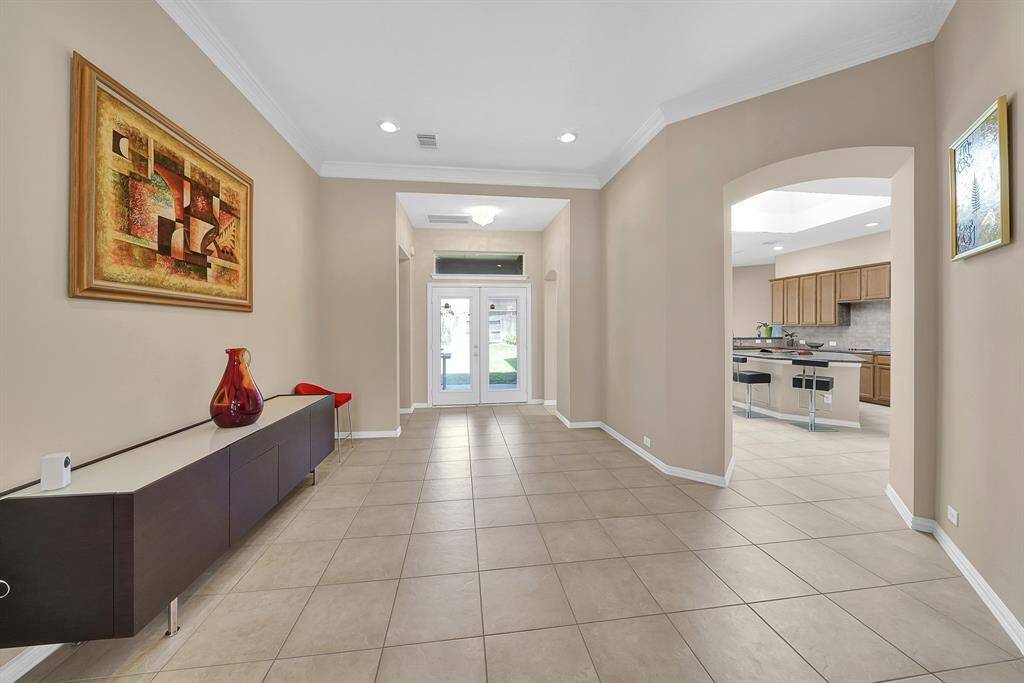Large foyer can be used for formal sitting and provides extra space for seating for holidays. (View from the front door: dining room to the right, bonus room and half bath to the left, back patiio straigt ahead, and kitchen top right.