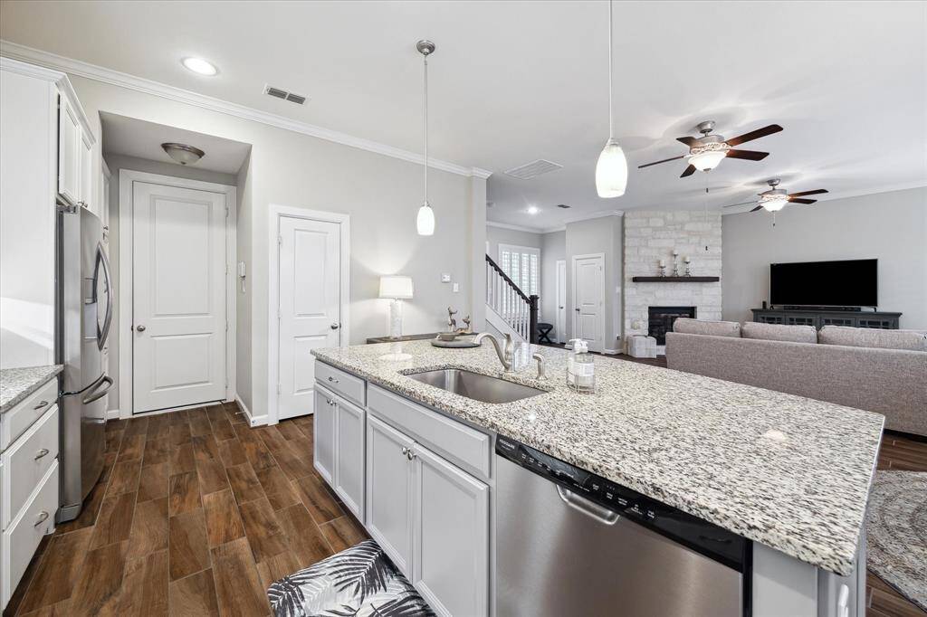 Great view from the kitchen to the front door and living space. Generous square footage allows for creative ways to stage and furnish.