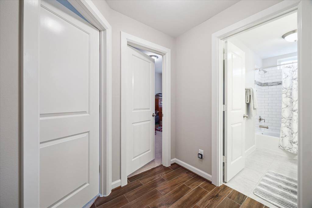 Just a peak to the third bedroom.  The current owner is using for storage. Convenient access to the secondary bathroom. Consistent flooring throughout the living space and carpet in each bedroom.