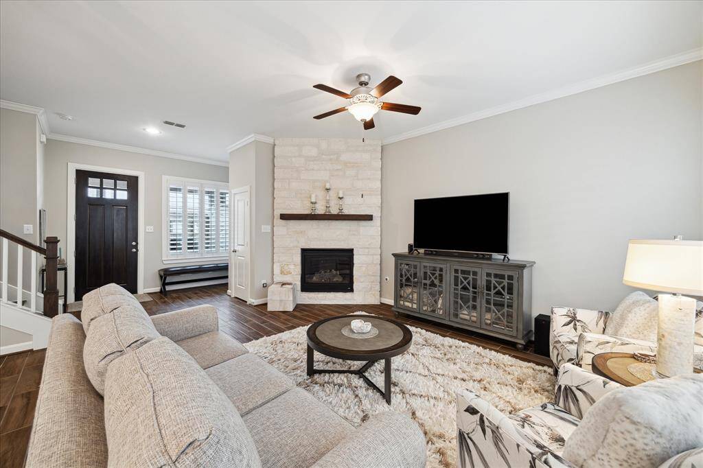 This inviting living room, with ceiling fan for comfort, while neutral tones enhance the modern decor. The room is spacious, perfect for relaxation and entertainment.