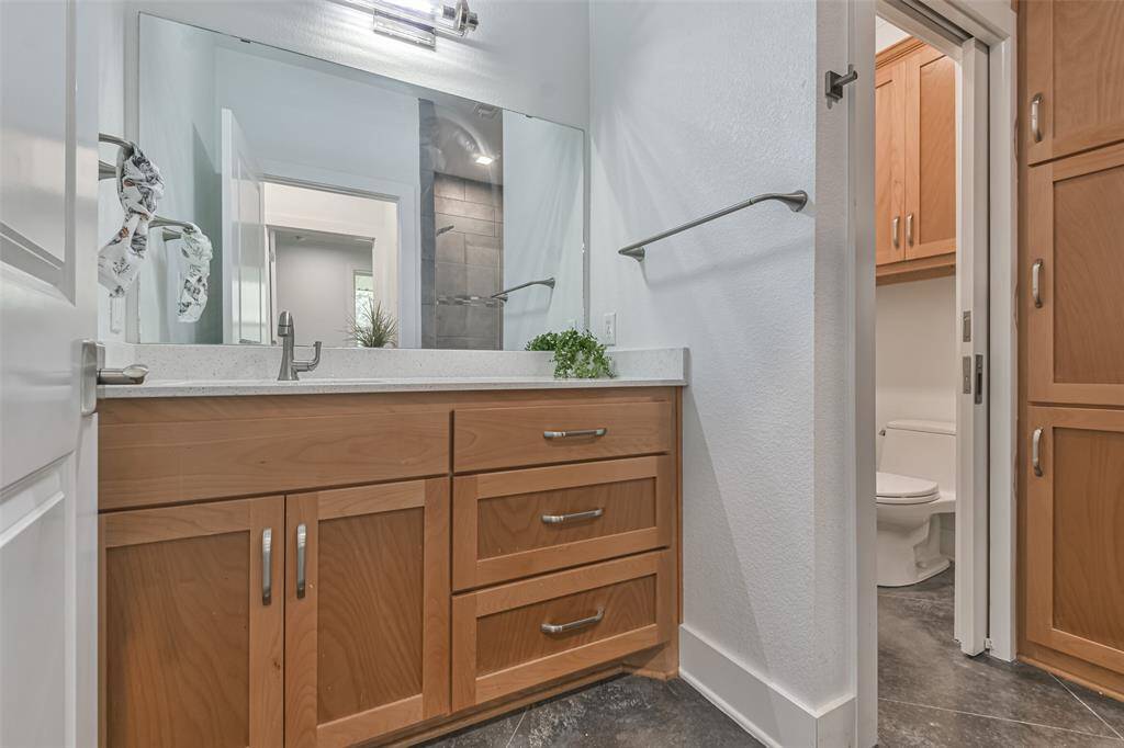 Full secondary bath featuring built-in storage and vanity space