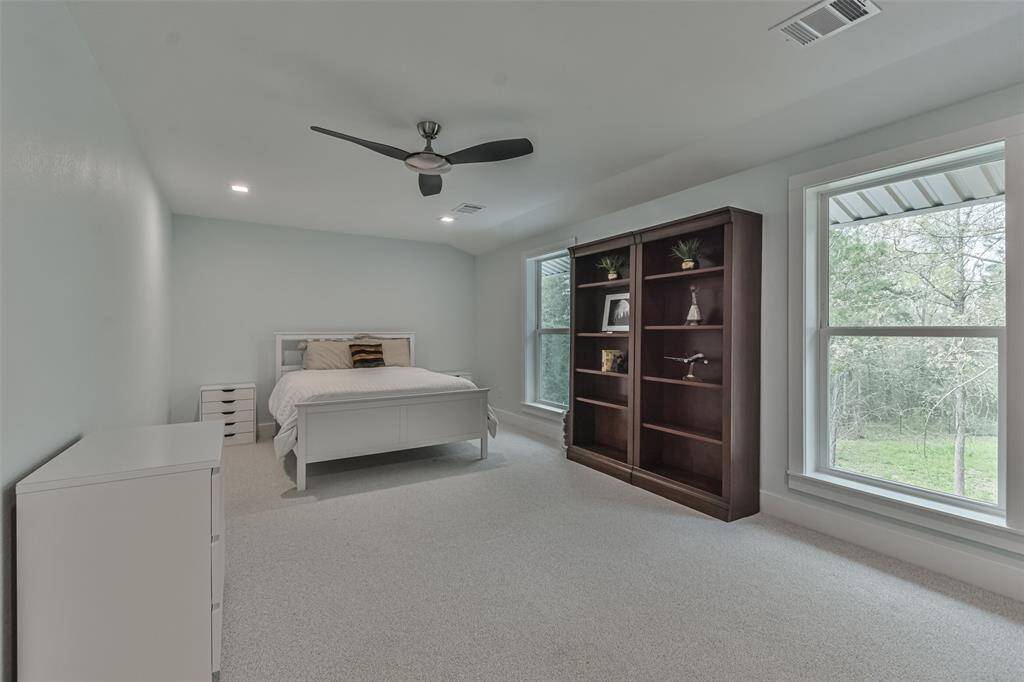 Flex room suitable for an additional bedroom, office, craft room, or reading space, with a large storage area that can be converted into a walk-in closet
