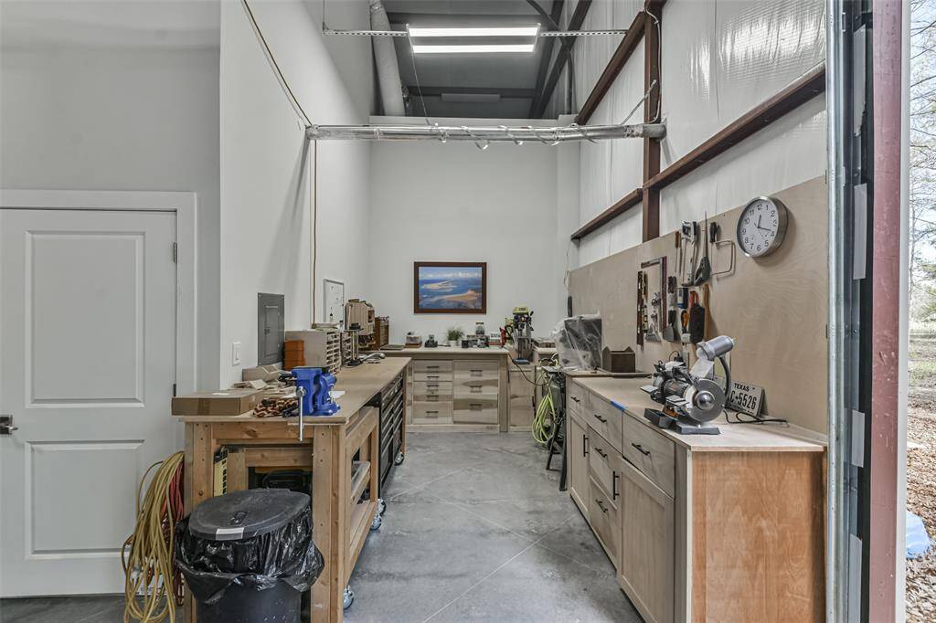 The workshop features custom-built cabinetry and counter space