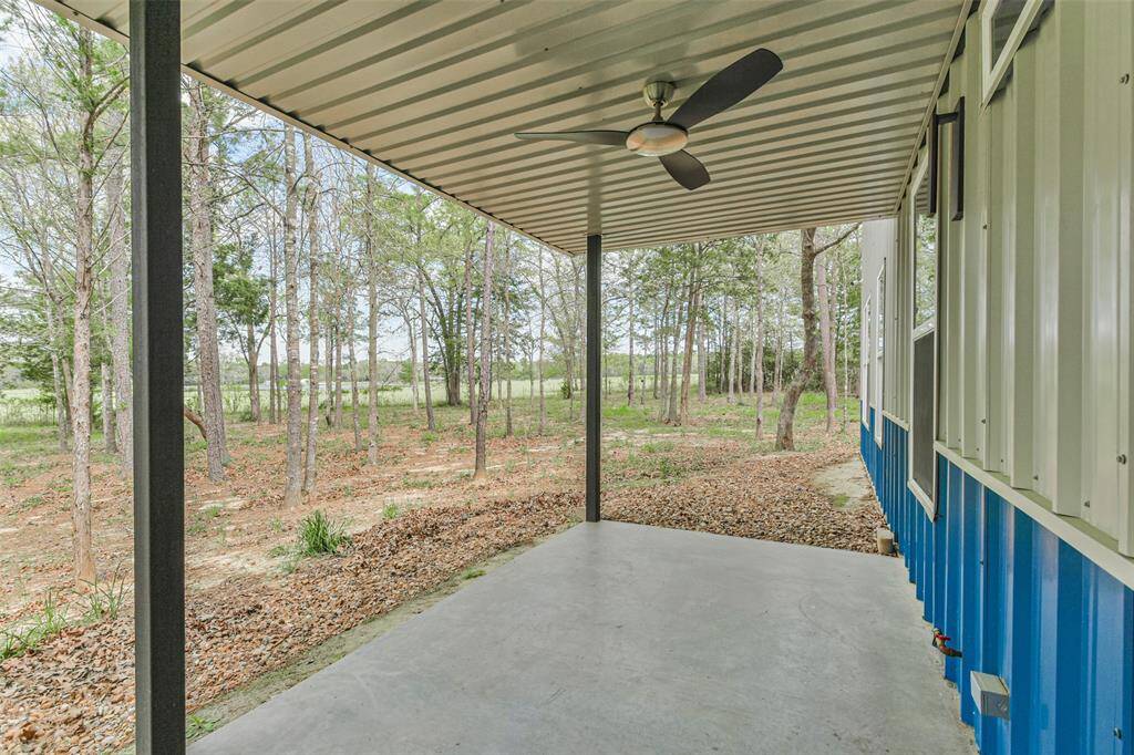 Revel in breathtaking views of the neighboring lake from the porch, offering a private backyard setting