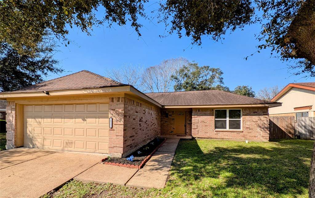Charming single-story brick home with a two-car garage and a neatly landscaped front yard. The property features a welcoming entrance and ample natural light, ideal for comfortable living.