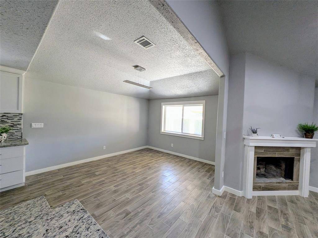 The space features modern finishes and connects to a dinning room.